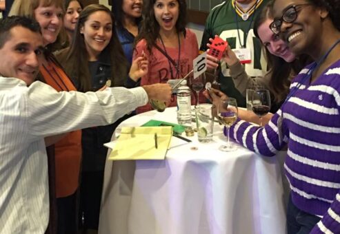 Employees having fun while drinking wine