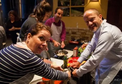 Employees enjoying helping each other while cooking
