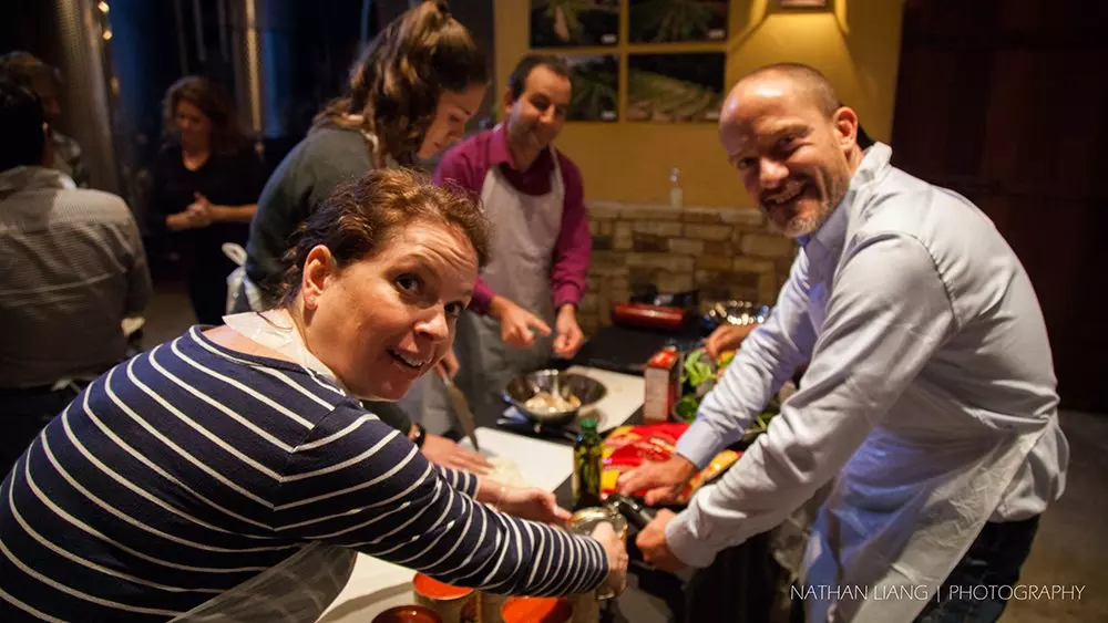 Employees enjoying helping each other while cooking