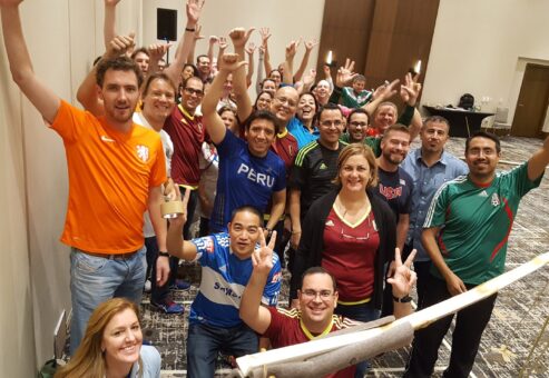 Group of people taking their Pictures while raising their hands