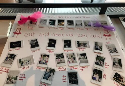 A display board from a Polaroid scavenger hunt themed 'Out and About with Team Tutu.' The board features instant photos taken at Lincoln Park Zoo, adorned with hand-drawn stick figures in tutus and decorated with small pink and purple tutu accents. Each photo is captioned with playful notes about team challenges and activities, showcasing the fun and lighthearted atmosphere of this creative team building event.