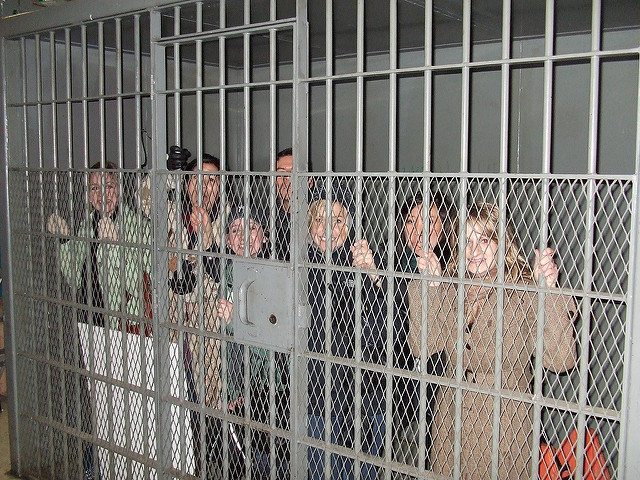 Employees pose inside the cell during the outdoor team building