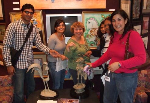 Employees surrounded by art