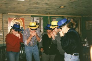 Employees wearing cowboy hats during their team building activity
