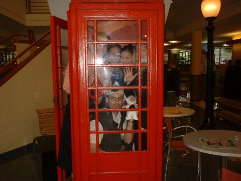 Bunch of people inside a telephone booth
