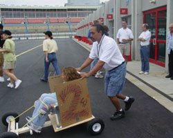 An Employee pushing a cart to the parking lot