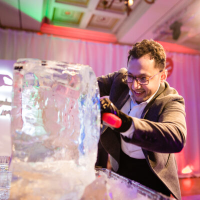 A participant skillfully chisels an ice block during an engaging Team building Ice Sculpting activity, focused on creativity and collaboration. thumbnail