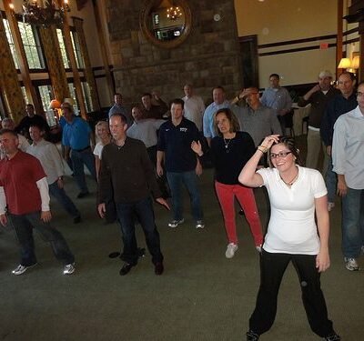 Employees having fun dancing at a Team Building Event organized by TeamBonding thumbnail
