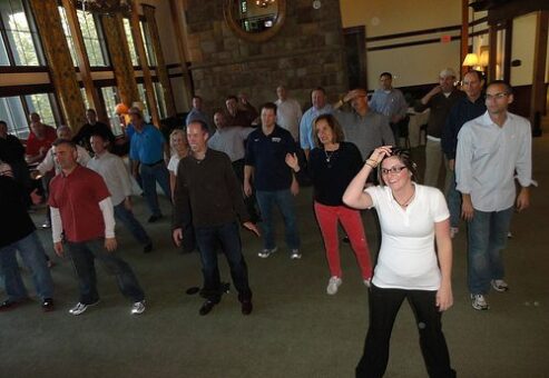 Employees having fun dancing at a Team Building Event organized by TeamBonding
