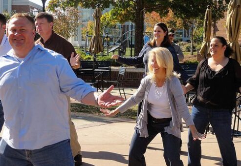 Employees having fun dancing at a Team Building Event organized by TeamBonding