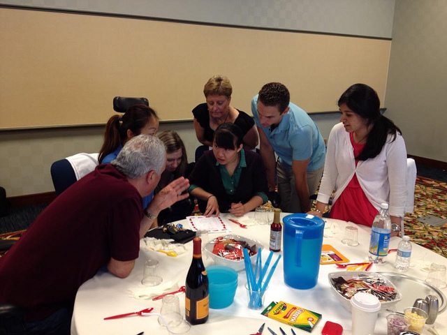 Employees and participants attentively took note as the manager gives an advice