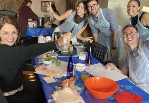 Participants happily preparing ingredients during a Wicked Good Chowda Cook-Off team building event.