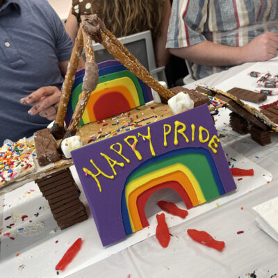 A colorful chocolate bridge constructed by a team during The Chocolate Challenge team building event. The bridge features a rainbow and a 