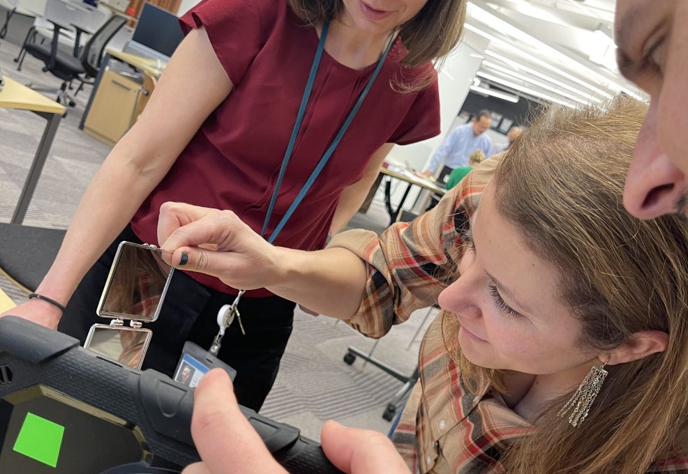 Group of colleagues reviewing evidence and analyzing a tablet during the Corporate CSI team building event.