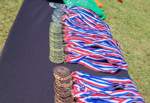 Medals and team flags displayed at an Outrageous Games team building event, ready for the award ceremony after a day of fun challenges.
