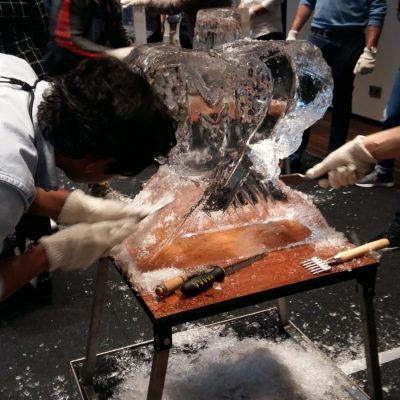 Participants work together to carve an intricate ice sculpture at a Team building Ice Sculpting event, demonstrating collaboration and creativity. thumbnail