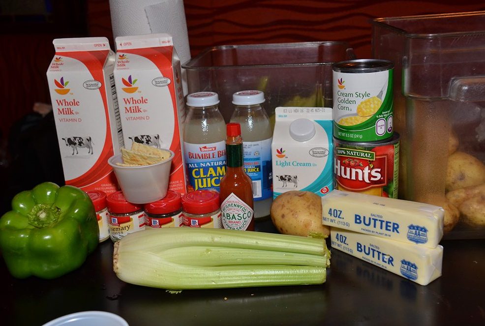 Fresh ingredients including milk, butter, celery, green pepper, and clam juice displayed for the Wicked Good Chowda Cook-Off team building event.