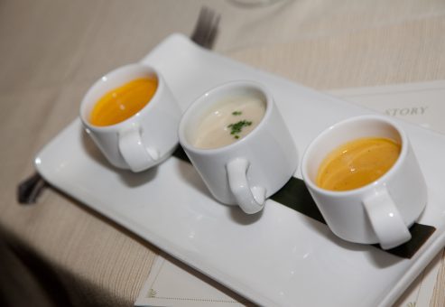 A selection of three different soups presented in small cups as part of the Dining in the Dark experience, highlighting the sensory nature of the event.
