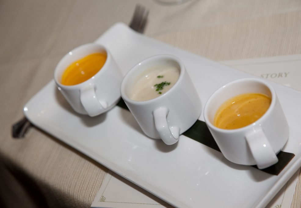 A selection of three different soups presented in small cups as part of the Dining in the Dark experience, highlighting the sensory nature of the event.