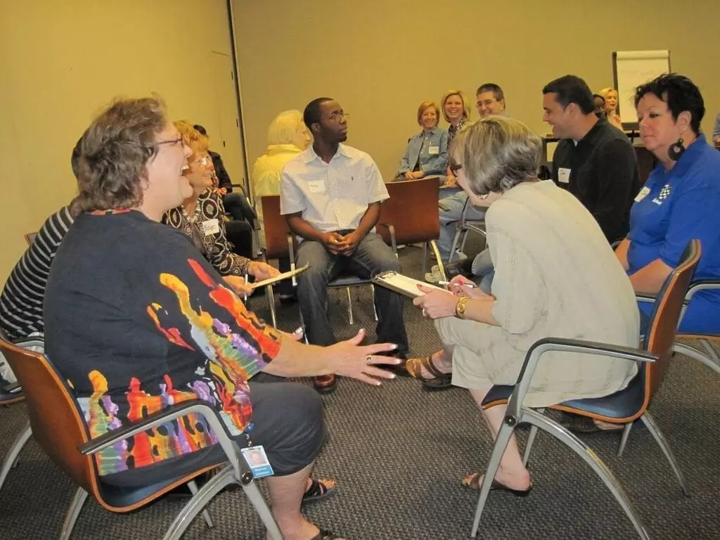 Employees and participants a happy team discussion during leadership training