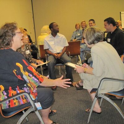 Employees and participants a happy team discussion during leadership training