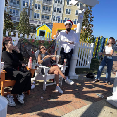 Participants engage in a scavenger hunt challenge during a Custom Team Building event. They are seated outdoors, fulfilling a task as part of the creative and interactive scavenger hunt activity. thumbnail