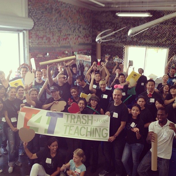 Employees holding a Trash4Training banner