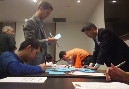 Employees and participants filling out the registration for during the Team building event