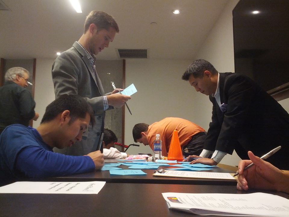 Employees and participants filling out the registration for during the Team building event
