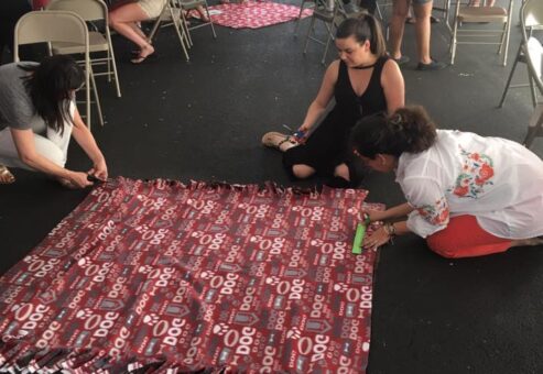 Participants at the Paws For A Cause team building event collaborate on creating colorful pull toys and cat scratch pads, crafting donations for local animal shelters to support animals in need.