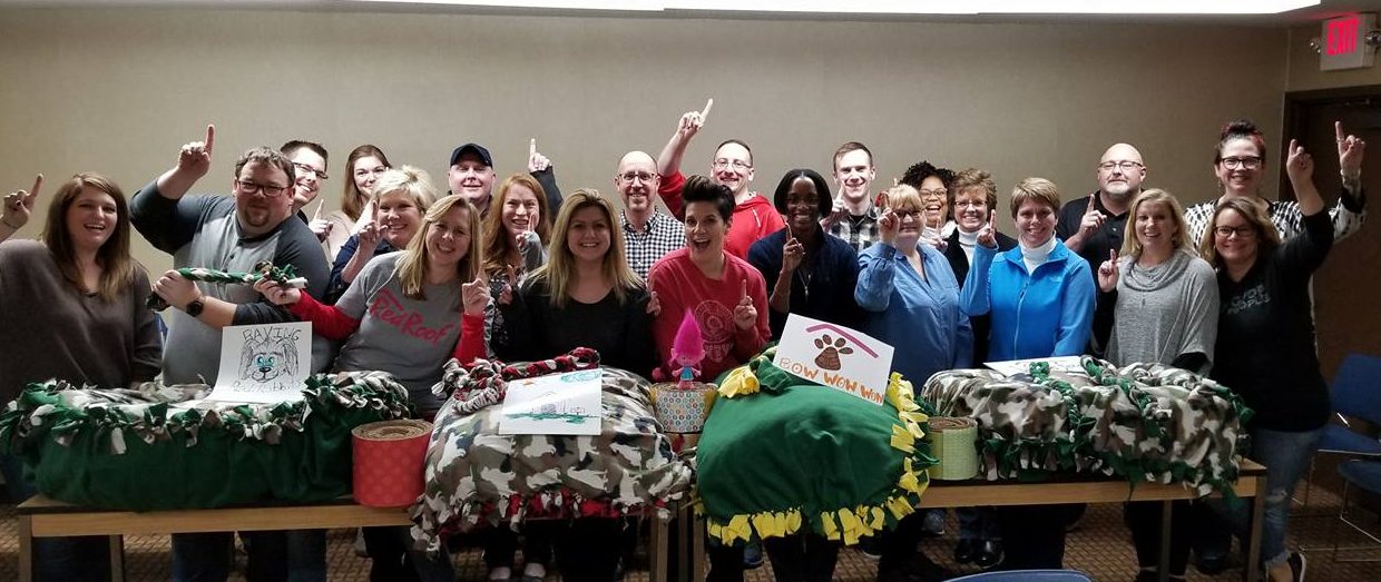 Team posing for photo at end of event with their finished doggy beds