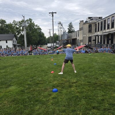 A group of people are participating in an outdoor activity on a lawn. It looks like a fun and engaging team building challenge. thumbnail
