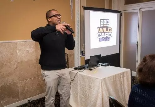 Event host leads the Wild Card Team Building Bingo session with enthusiasm, creating an engaging and lively atmosphere.