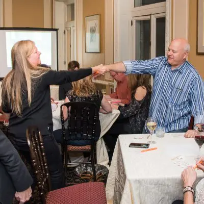 Participants completing a challenge during a Wild Card Team Building Bingo event. thumbnail