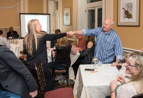 Participants completing a challenge during a Wild Card Team Building Bingo event.