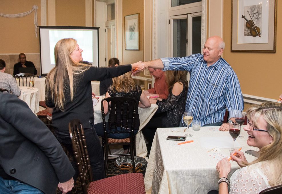 Participants completing a challenge during a Wild Card Team Building Bingo event.