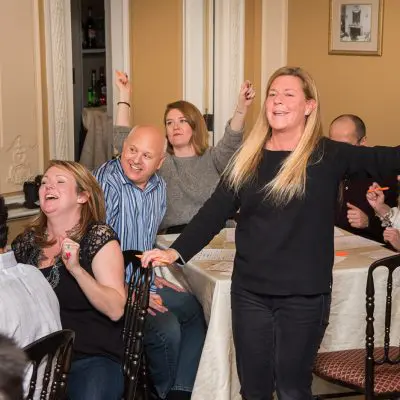 Participants celebrating and enjoying the Wild Card Team Building Bingo event with laughter and enthusiasm. thumbnail