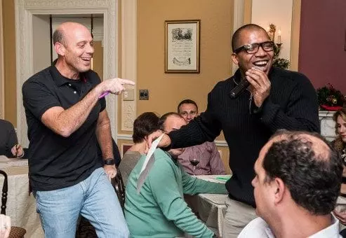 Event host leads the Wild Card Team Building Bingo session with enthusiasm, creating an engaging and lively atmosphere.