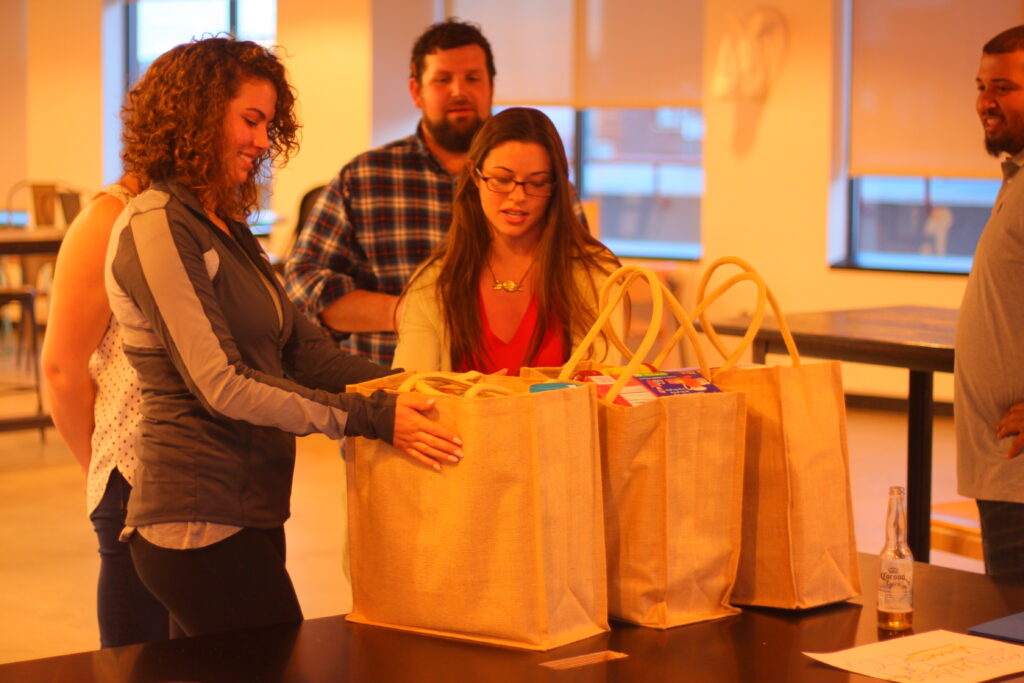 Employees and participants received their gifts while colleagues look on