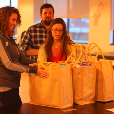Employees and participants received their gifts while colleagues look on