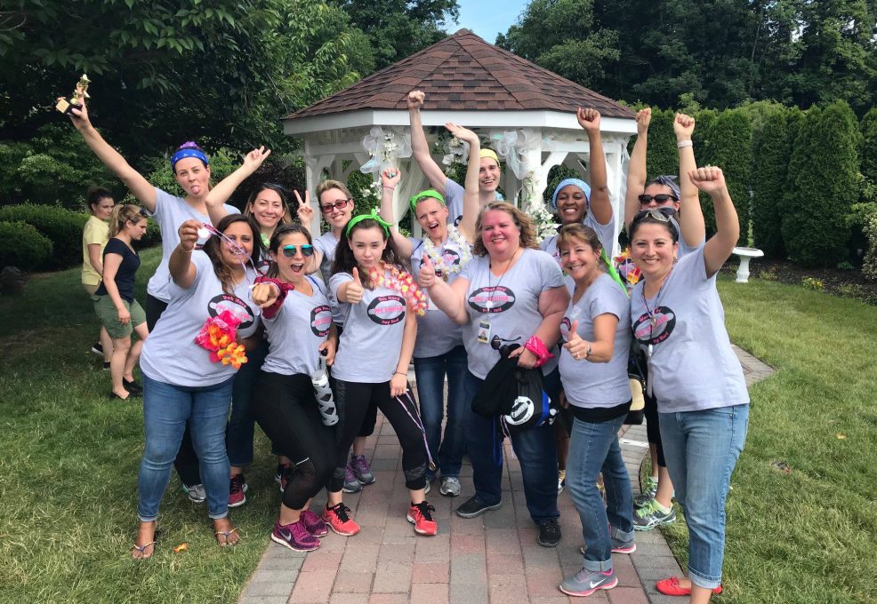A victorious team celebrating after completing challenges at the Corporate Survivor team building event, showcasing teamwork and success.