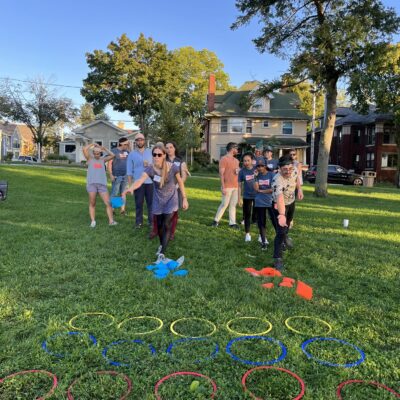 Team members participate in a hoop relay challenge during the Corporate Survivor team building event, focusing on coordination and teamwork. thumbnail