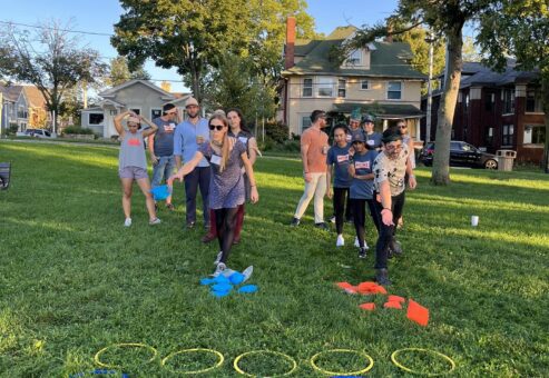 Team members participate in a hoop relay challenge during the Corporate Survivor team building event, focusing on coordination and teamwork.