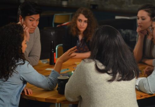 An employee share her thought as other attentively listen