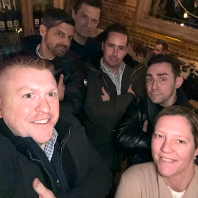 Team members pose confidently during a Pub Crawl Scavenger Hunt, enjoying the camaraderie and lighthearted competition of the event. thumbnail