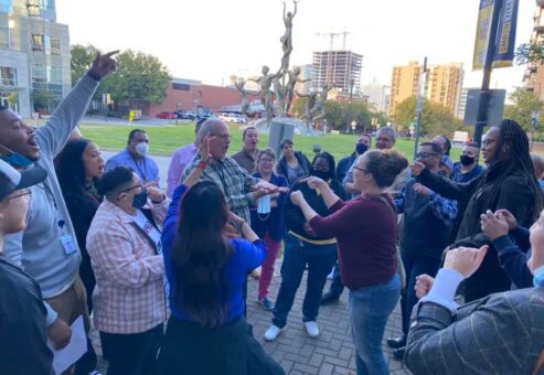 Participants energetically engaging in an outdoor challenge during the Pub Crawl Scavenger Hunt, fostering team spirit and connection in a lively city setting.