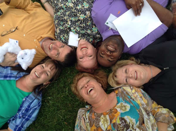 Employees having fun lying in the grass