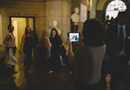 Co-workmate taking pictures with her friends by Teambonding