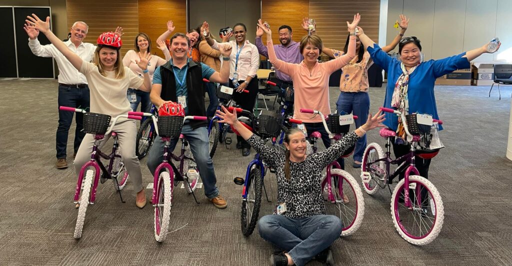 People celebrating their job at putting together bikes for charity
