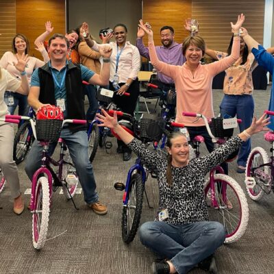 People celebrating their job at putting together bikes for charity